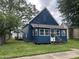 Charming blue home with a well-maintained front yard, inviting curb appeal and a quaint front porch at 3127 E Lynn St, Anderson, IN 46016