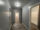 The hallway has wood floors and gray walls at 3127 E Lynn St, Anderson, IN 46016