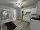 This kitchen features white cabinets, gray walls, and a ceiling fan at 3127 E Lynn St, Anderson, IN 46016