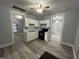 Modern kitchen featuring updated appliances, bright cabinets, and hardwood floors at 3127 E Lynn St, Anderson, IN 46016