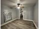Bright living room featuring light grey walls, modern floors, ceiling fan, and lots of natural light at 3127 E Lynn St, Anderson, IN 46016