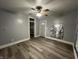 Bright living room featuring light grey walls, modern floors, ceiling fan, and lots of natural light at 3127 E Lynn St, Anderson, IN 46016