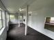 Enclosed front porch with neutral colors, multiple windows, and an exterior door at 3127 E Lynn St, Anderson, IN 46016