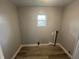 This room features a small window and wood floors at 3127 E Lynn St, Anderson, IN 46016