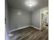 This room has gray walls and wood floors at 3127 E Lynn St, Anderson, IN 46016