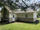 Side and rear view of home featuring updated siding and rear entrance at 321 S 23Rd St, Elwood, IN 46036