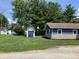 View of backyard with lush green lawn and storage building at 321 S 23Rd St, Elwood, IN 46036