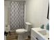 Bright bathroom featuring white vanity, patterned shower curtain, and modern toilet at 321 S 23Rd St, Elwood, IN 46036