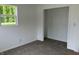 Bright bedroom featuring a sunlit window, closet, and carpet at 321 S 23Rd St, Elwood, IN 46036