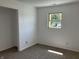 Inviting bedroom with plush carpet, closet, and a window showcasing an exterior view at 321 S 23Rd St, Elwood, IN 46036