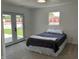 Cozy bedroom with carpet flooring, a comfortable bed, and access to an outdoor area through French doors at 321 S 23Rd St, Elwood, IN 46036