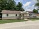 An attractive single-story home with stone foundation, siding, manicured lawn, and a clear 'For Sale' sign at 321 S 23Rd St, Elwood, IN 46036