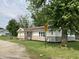 View of the front of the house with the updated siding and cozy front porch at 321 S 23Rd St, Elwood, IN 46036