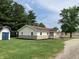 View of the front of the house with storage building and updated siding at 321 S 23Rd St, Elwood, IN 46036