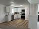 Modern kitchen featuring white cabinets, stainless steel appliances, and a new laminate floor at 321 S 23Rd St, Elwood, IN 46036