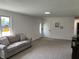 Inviting living room features new carpet, fresh paint, and ample natural light at 321 S 23Rd St, Elwood, IN 46036