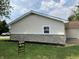 Side exterior view with siding and updated rock facade at 321 S 23Rd St, Elwood, IN 46036