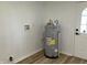 Utility room featuring a water heater and laminate flooring at 321 S 23Rd St, Elwood, IN 46036