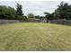 Large, fenced backyard features lush green grass and mature trees, offering privacy at 3327 Boxwood Dr, Indianapolis, IN 46227