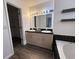Bathroom with double sink vanity, tub, and walk-in closet at 3327 Boxwood Dr, Indianapolis, IN 46227