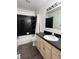Bathroom with black and white tiled shower and dark countertop at 3327 Boxwood Dr, Indianapolis, IN 46227