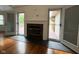 Cozy fireplace with access to outdoor deck through double glass doors at 3327 Boxwood Dr, Indianapolis, IN 46227