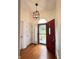 Inviting foyer featuring hardwood floors and a stylish light fixture at 3327 Boxwood Dr, Indianapolis, IN 46227