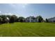 Expansive backyard featuring a lush lawn, mature trees, and a charming playset at 3610 Homestead Pl, Plainfield, IN 46168