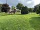 Beautiful backyard with lush green grass, mature trees, and a black fence surrounding the property at 3610 Homestead Pl, Plainfield, IN 46168