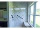 Bathroom features a modern shower with marble wall, built-in bench, and hand rails at 3610 Homestead Pl, Plainfield, IN 46168
