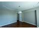 Well-lit bedroom with neutral walls, modern lighting, and hardwood floors at 3610 Homestead Pl, Plainfield, IN 46168