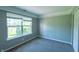 This bedroom includes neutral walls, carpeted floors, trim and a bright window at 3610 Homestead Pl, Plainfield, IN 46168