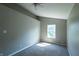 This bedroom offers neutral walls, carpet, and a window for natural light at 3610 Homestead Pl, Plainfield, IN 46168