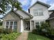 Inviting front entrance with gray brick and white siding, complemented by well-maintained landscaping at 3610 Homestead Pl, Plainfield, IN 46168