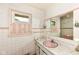 Bathroom featuring tile and classic fixtures, with a window for natural light at 3636 Oakwood Dr, Anderson, IN 46011