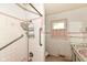 Bathroom featuring tile, shower, and classic fixtures, with a window for natural light at 3636 Oakwood Dr, Anderson, IN 46011