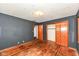 Bedroom with hardwood floors, two windows, and a closet with wood doors at 3636 Oakwood Dr, Anderson, IN 46011