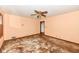Bright bedroom with window, ceiling fan, neutral walls, and potential to be refreshed at 3636 Oakwood Dr, Anderson, IN 46011