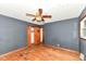 Bedroom showcasing hardwood floors and closet space with a ceiling fan at 3636 Oakwood Dr, Anderson, IN 46011