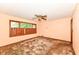 Cozy bedroom with large window overlooking trees, a ceiling fan, and potential for customization at 3636 Oakwood Dr, Anderson, IN 46011