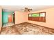 Bedroom with a ceiling fan, natural light from a large window, and a view into an adjacent room at 3636 Oakwood Dr, Anderson, IN 46011