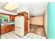 Cozy kitchen featuring wood cabinets, a window over the sink, and an adjacent dining area at 3636 Oakwood Dr, Anderson, IN 46011