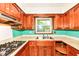Kitchen with wooden cabinets, stainless steel sink, and window providing natural light at 3636 Oakwood Dr, Anderson, IN 46011