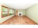 Spacious living room with large windows overlooking the front yard and a traditional fireplace as a focal point at 3636 Oakwood Dr, Anderson, IN 46011