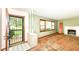 Living room featuring a fireplace, a large window letting in natural light, and original architectural details at 3636 Oakwood Dr, Anderson, IN 46011