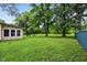 Large backyard with mature trees and green grass with views of the house at 3921 S Lasalle St, Indianapolis, IN 46237