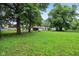 Spacious backyard featuring mature trees and partial view of house and fence at 3921 S Lasalle St, Indianapolis, IN 46237