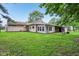 A spacious backyard featuring green grass, mature trees and view of the home at 3921 S Lasalle St, Indianapolis, IN 46237
