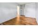 Neutral bedroom featuring wood floors, closet, and open doorway to next room at 3921 S Lasalle St, Indianapolis, IN 46237