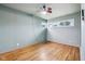 Empty bedroom with wood paneling features a fan and hardwood floors at 3921 S Lasalle St, Indianapolis, IN 46237